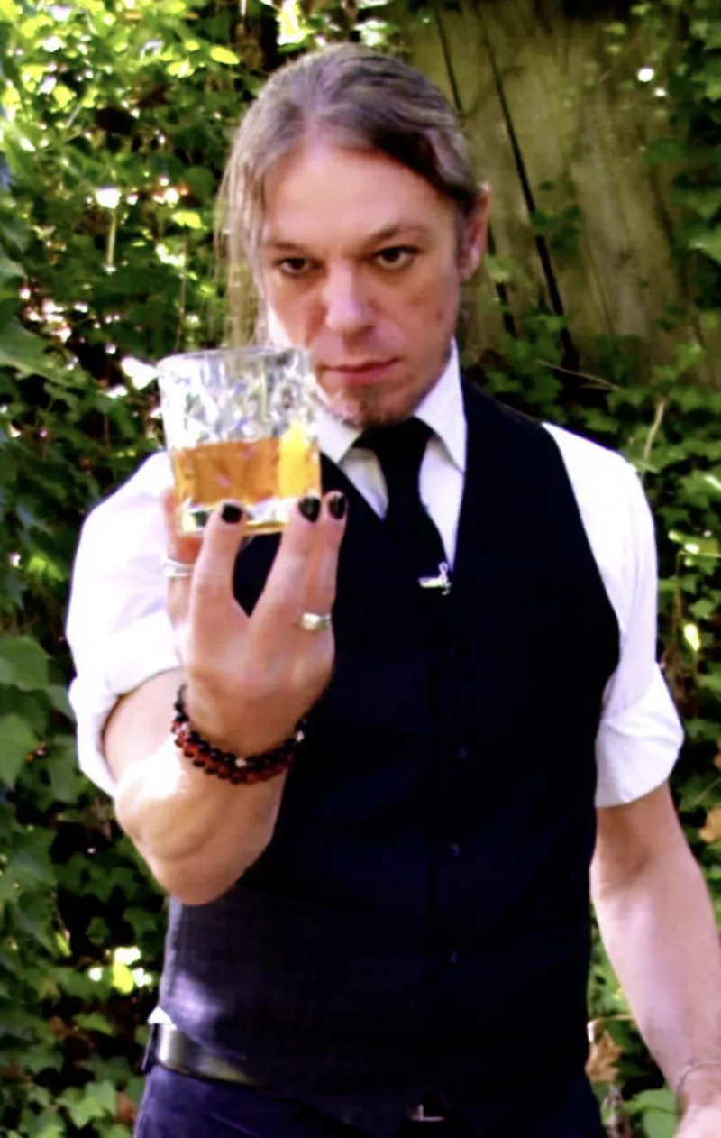 Mixologist Vince Clifton holding a finished cocktail