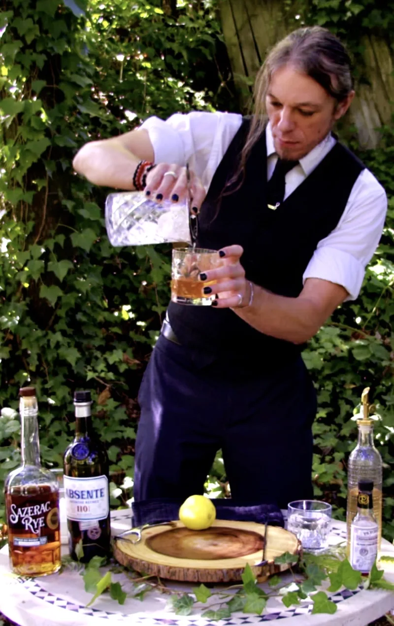 Vince Clifton pouring a cocktail at an outdoor bar